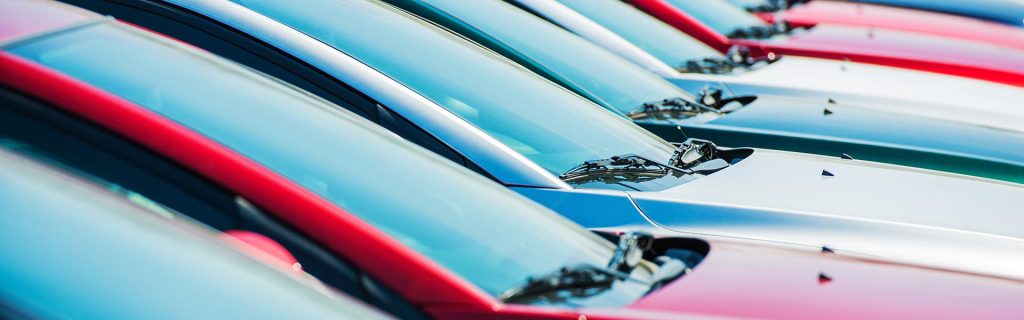 Row of colorful cars parked side-by-side.